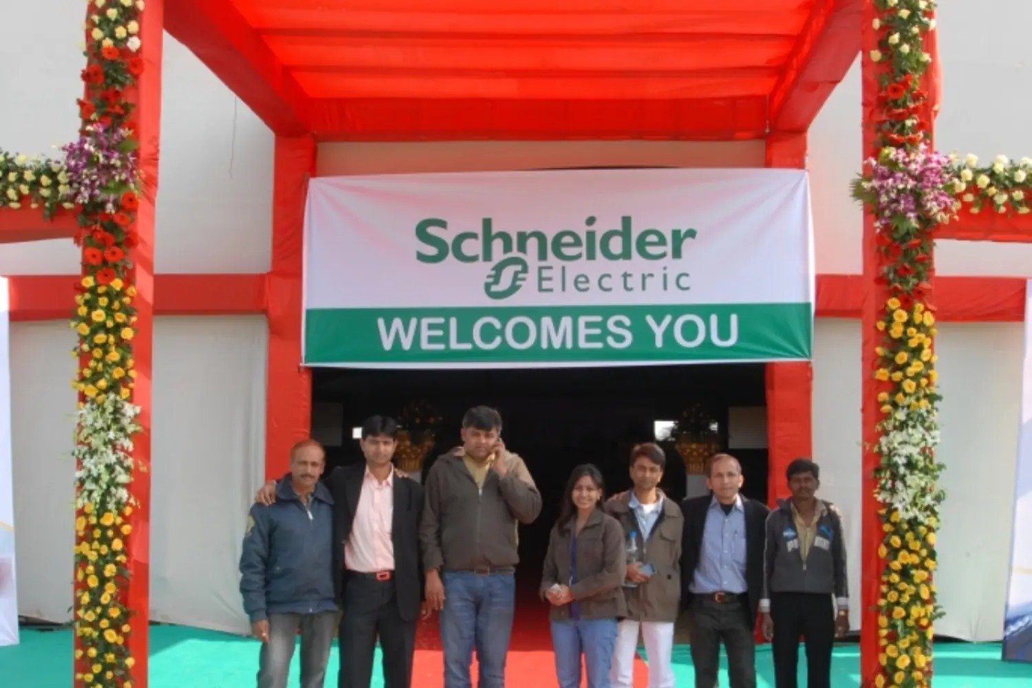 Man and woman speaking on stage at night with blue lighting